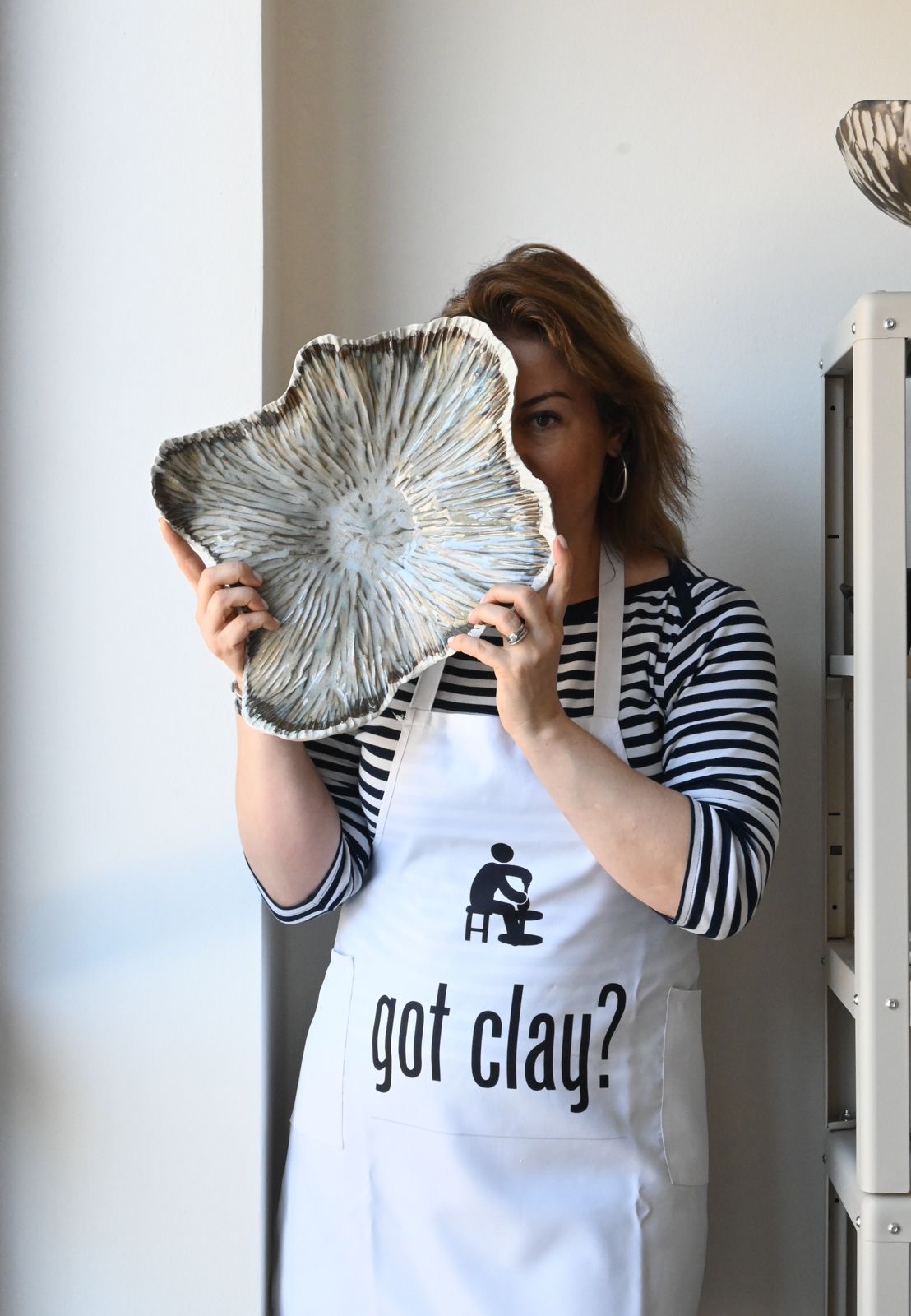 Sophia holding one of her ceramic plates